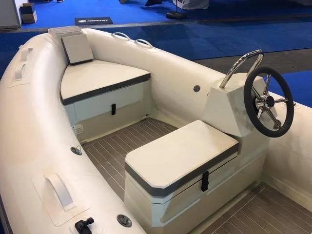 Slide: The Image of 2023 ZAR Mini LUX 12 inflatable boat interior with steering wheel and seating. - 4