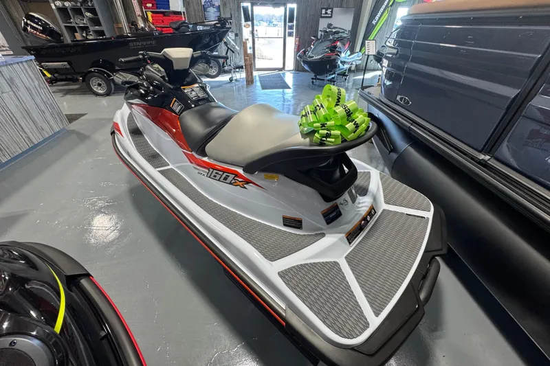 Slide: The Image of 2025 Kawasaki STX160X jet ski in showroom, featuring sleek design and vibrant colors. - 8