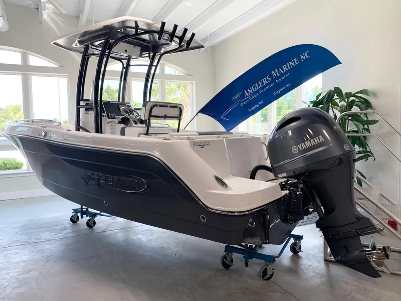 Slide: The Image of 2024 Robalo R222 boat with Yamaha engine displayed at Anglers Marine NC showroom. - 0