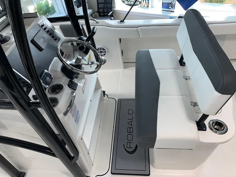 Slide: The Image of 2024 Robalo R222 boat interior with steering wheel and seating. - 4