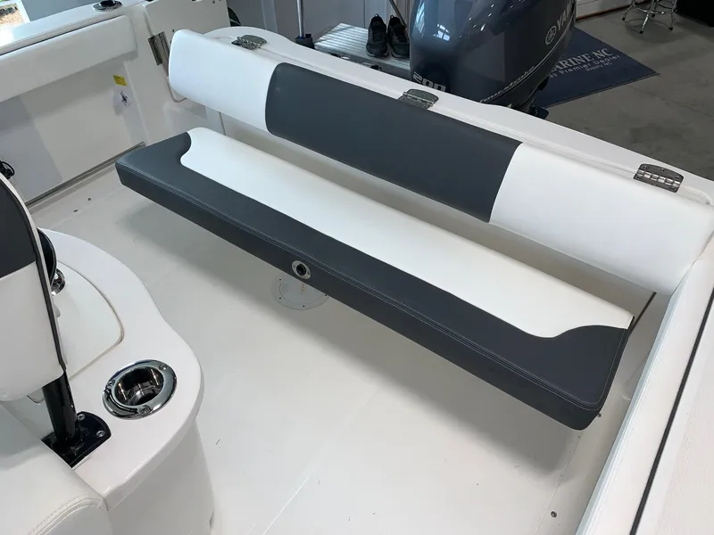 Slide: The Image of 2024 Robalo R222 boat interior seating with white and gray upholstery. - 5