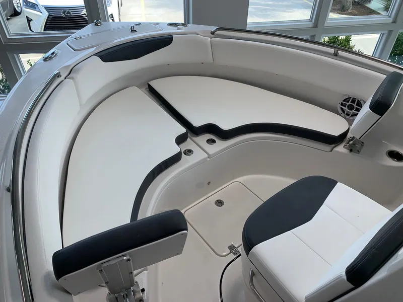 Slide: The Image of 2024 Robalo R222 boat interior with white and black seating. - 10