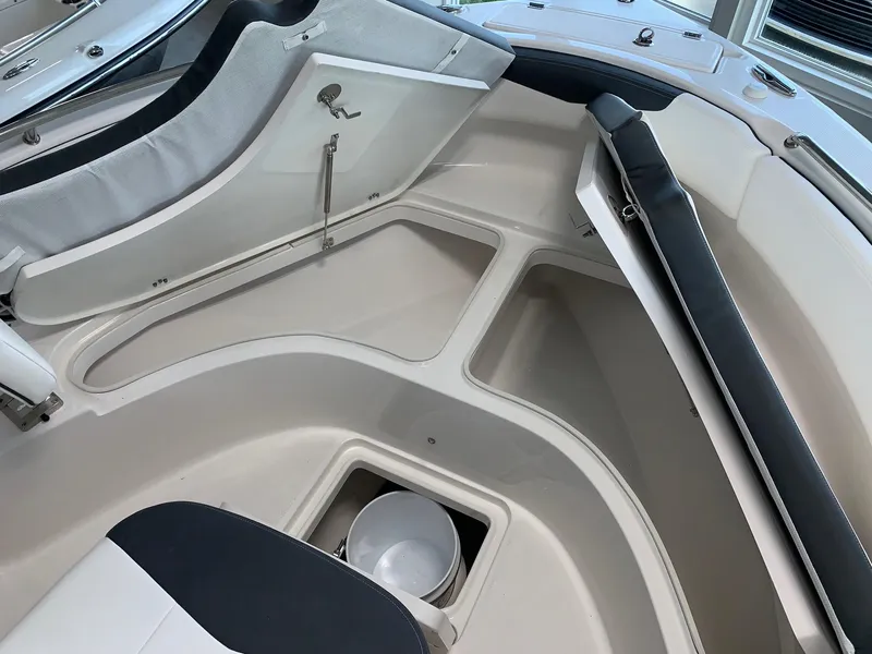 Slide: The Image of 2024 Robalo R222 boat interior with storage compartments and seating. - 11