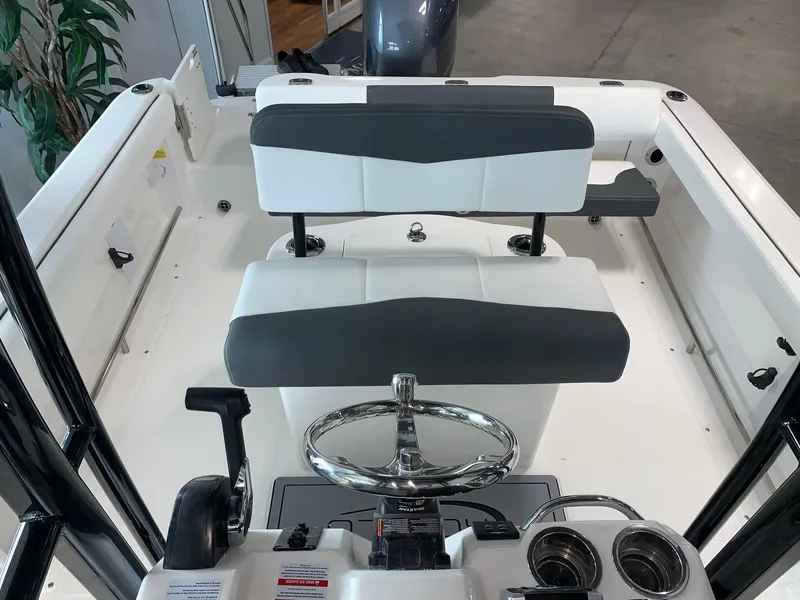 Slide: The Image of 2024 Robalo R222 boat interior with dual seating and steering wheel. - 6