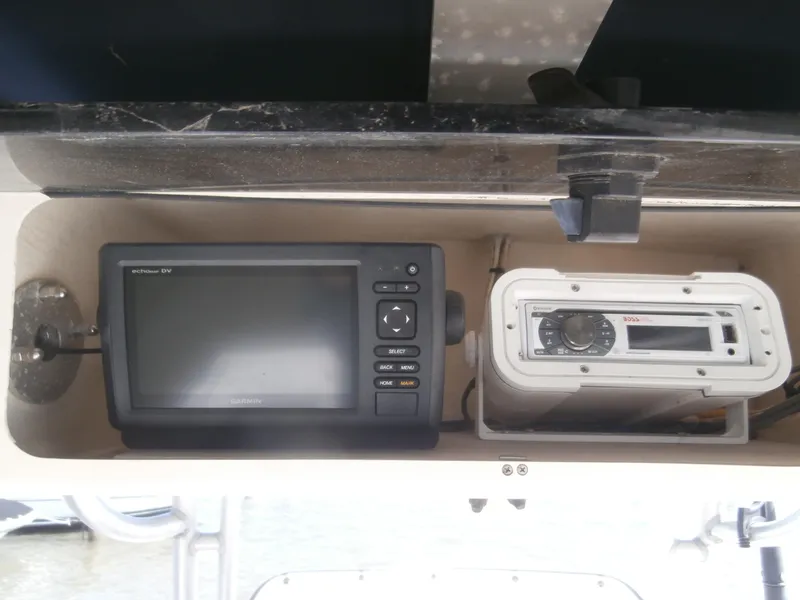 Slide: The Image of 2004 Grady-White 22 FISHERMAN boat electronics, featuring a GPS and stereo system. - 14