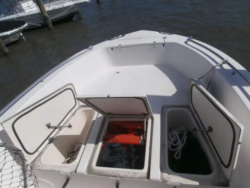Slide: The Image of 2004 Grady-White 22 FISHERMAN boat with open storage compartments on deck. - 7
