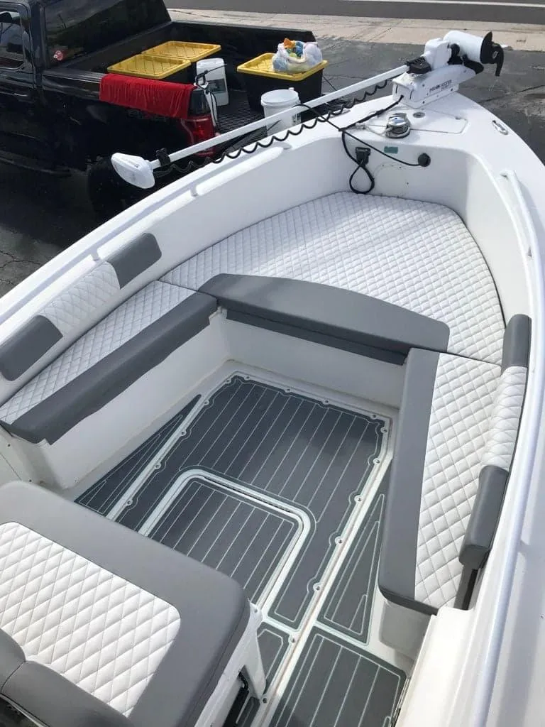 Slide: The Image of 2006 Everglades 243 CC boat with cushioned seating and modern deck design. - 12