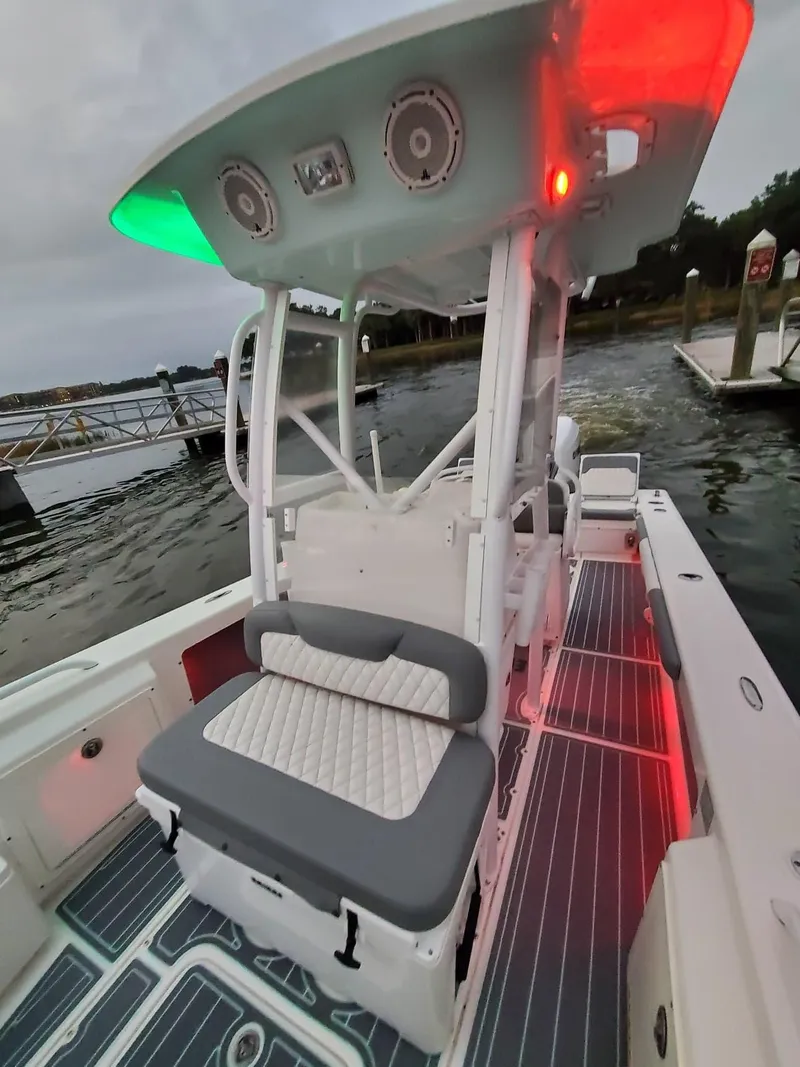 Slide: The Image of 2006 Everglades 243 CC boat with illuminated T-top and cushioned seating. - 14