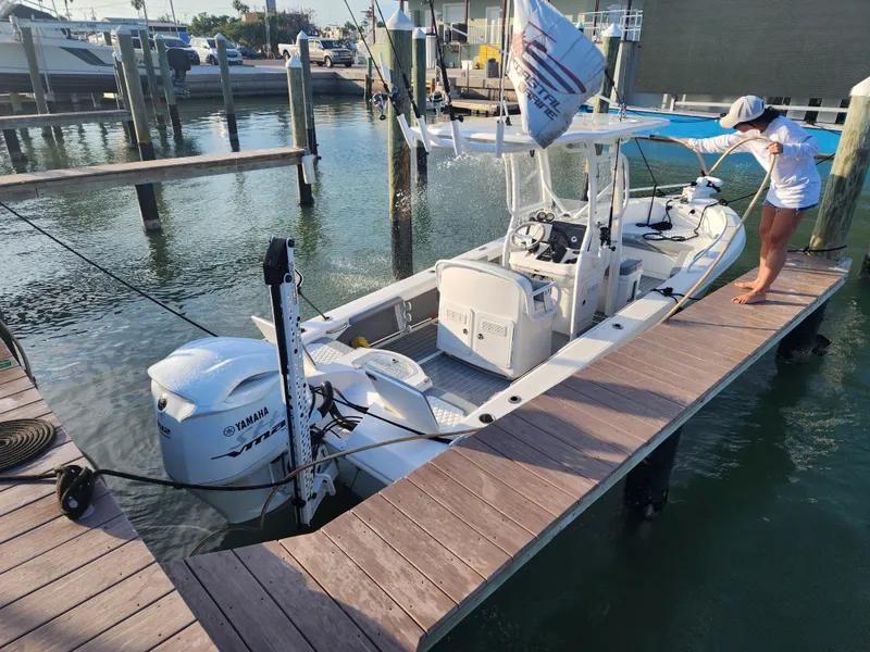 Slide: The Image of 2006 Everglades 243 CC boat docked with Yamaha outboard engine. - 17