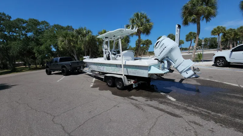 Slide: The Image of 2006 Everglades 243 CC boat on trailer in parking lot with palm trees. - 18