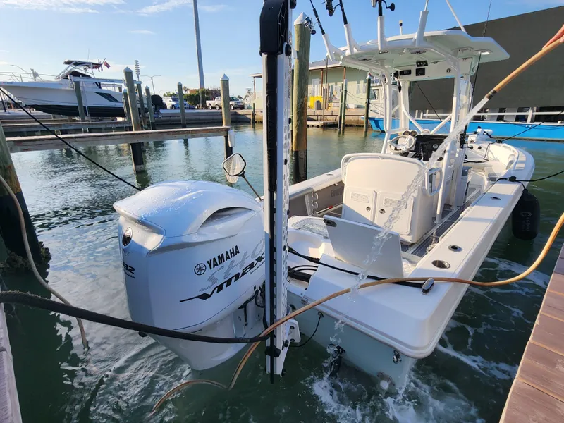 Slide: The Image of 2006 Everglades 243 CC boat with Yamaha outboard motor docked in marina. - 21