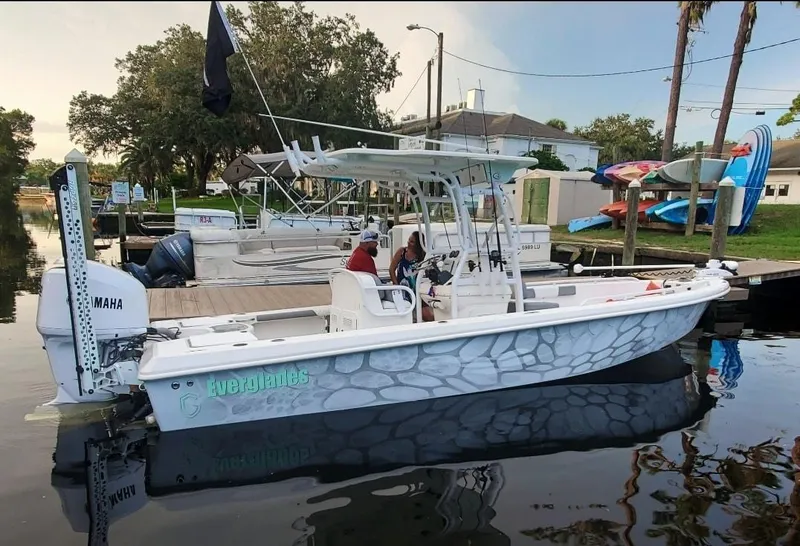 Slide: The Image of 2006 Everglades 243 CC boat docked with Yamaha outboard motor. - 24