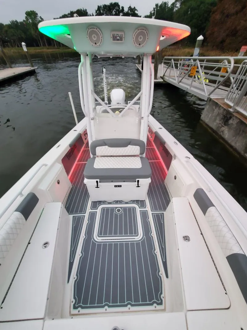 Slide: The Image of 2006 Everglades 243 CC boat with illuminated deck and seating at a dock. - 29