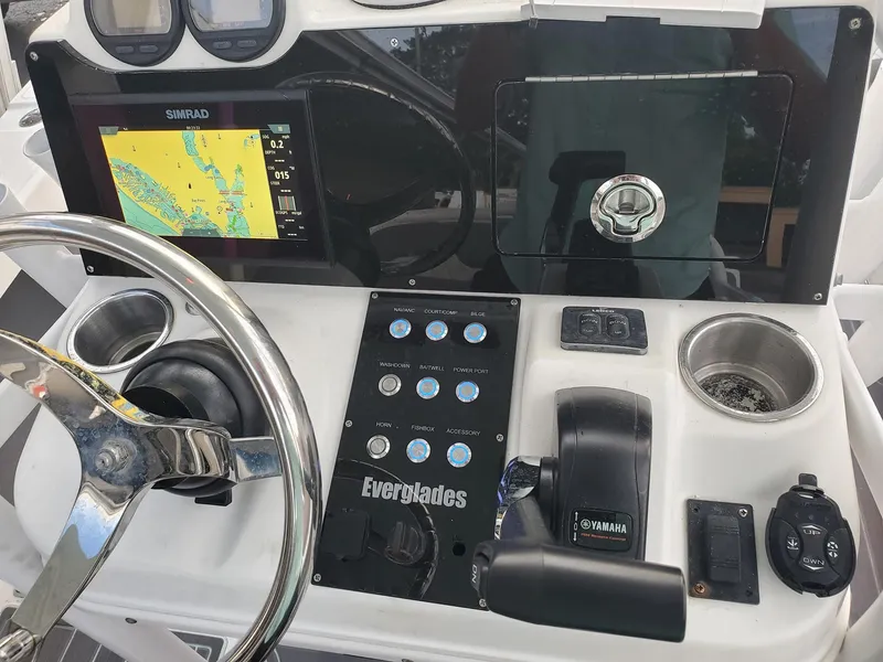 Slide: The Image of 2006 Everglades 243 CC boat dashboard with Simrad navigation system and Yamaha controls. - 3