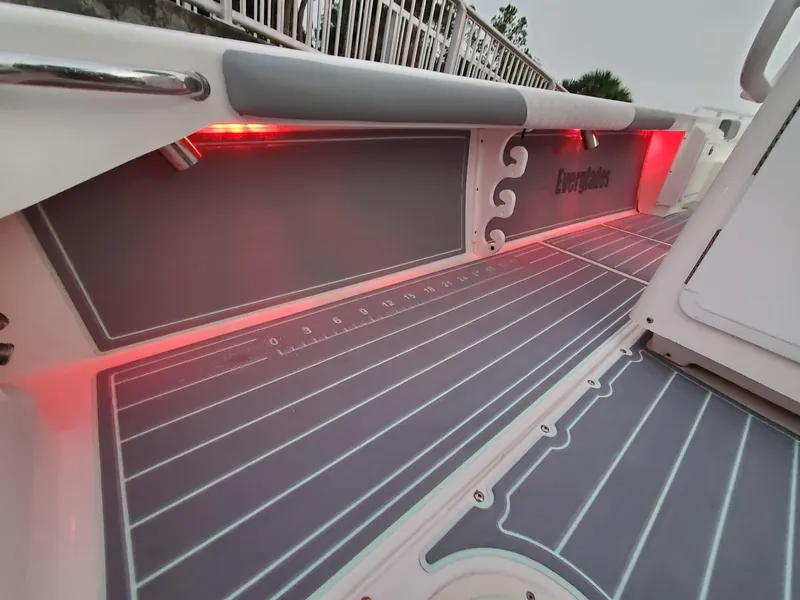 Slide: The Image of 2006 Everglades 243 CC boat deck with red LED lighting and cushioned side panels. - 32
