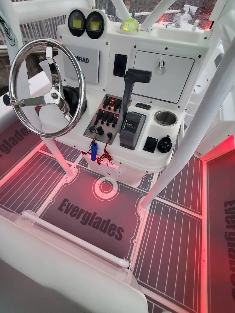 Slide: The Image of 2006 Everglades 243 CC boat console with illuminated deck and modern controls. - 33