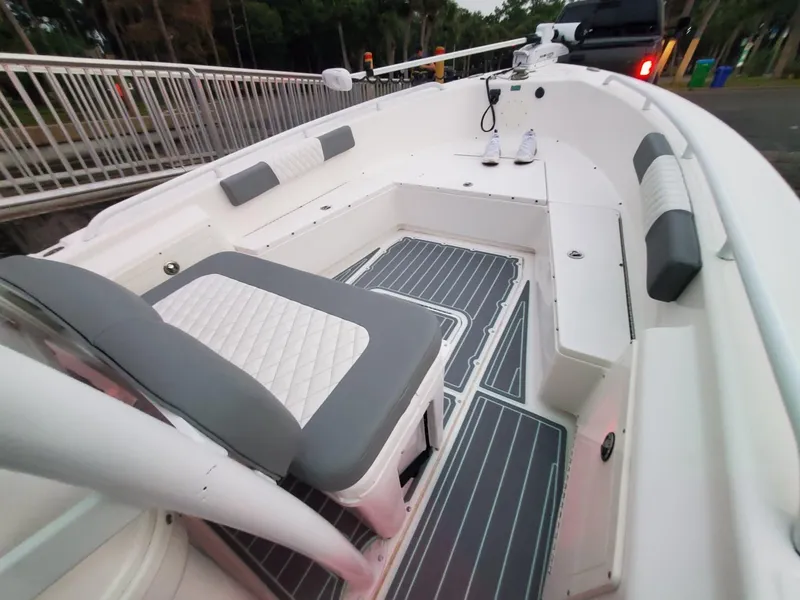 Slide: The Image of 2006 Everglades 243 CC boat interior with cushioned seating and non-slip flooring. - 34