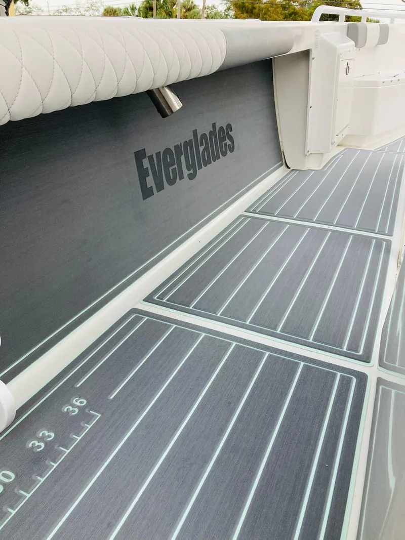 Slide: The Image of 2006 Everglades 243 CC boat deck with cushioned seating and branded side panel. - 37