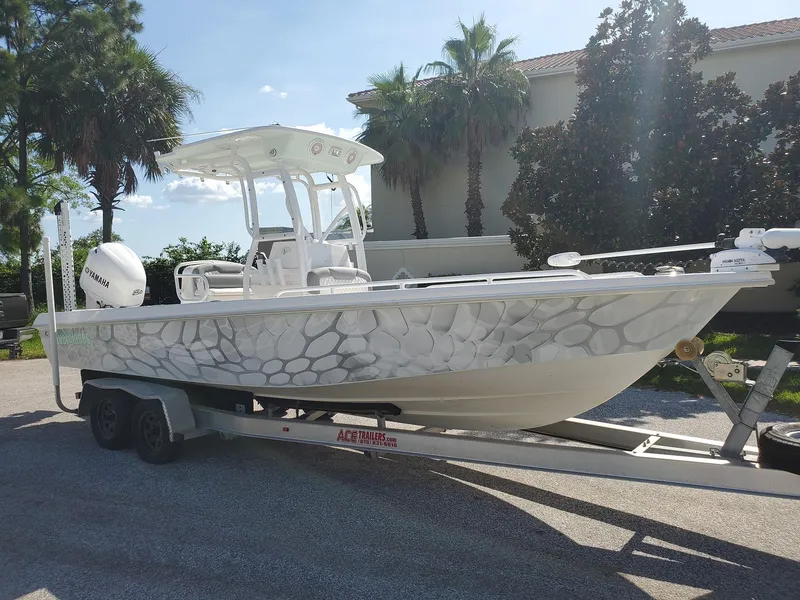 Slide: The Image of 2006 Everglades 243 CC boat on a trailer with a unique patterned hull design. - 38