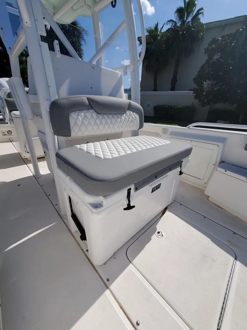 Slide: The Image of 2006 Everglades 243 CC boat with cushioned seating and storage. - 42