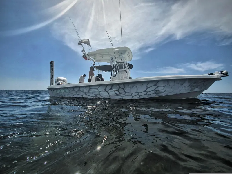 Slide: The Image of 2006 Everglades 243 CC boat on open water under a sunny sky. - 45
