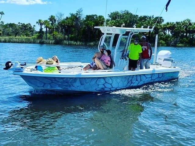 Slide: The Image of 2006 Everglades 243 CC boat cruising on a sunny day with passengers. - 49