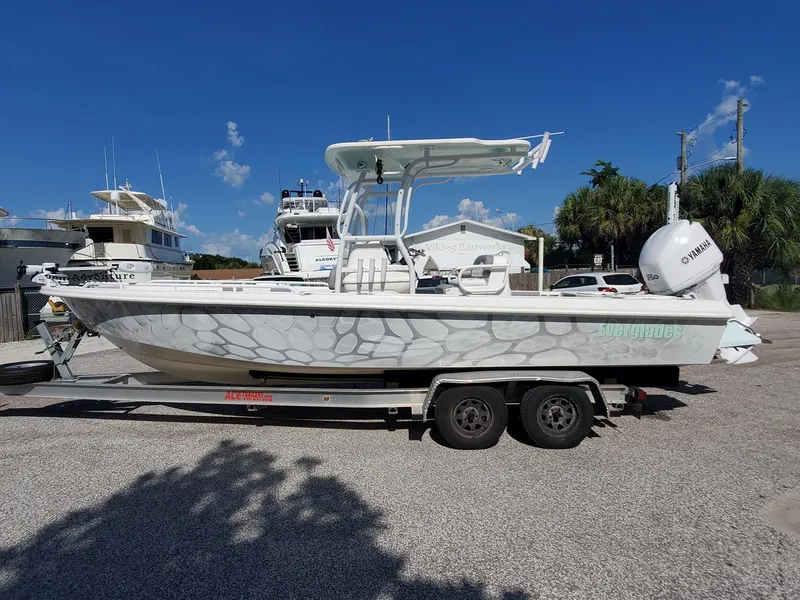 Slide: The Image of 2006 Everglades 243 CC boat on a trailer in a marina parking lot. - 50