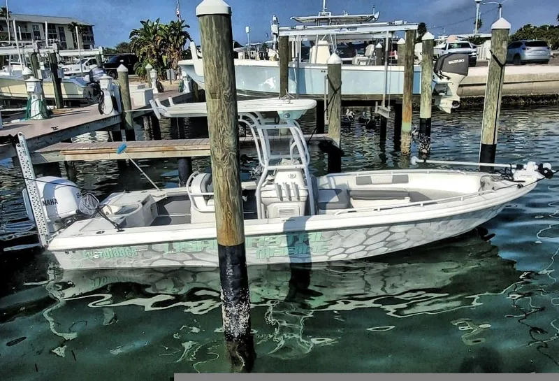 Slide: The Image of 2006 Everglades 243 CC boat docked at a marina. - 7