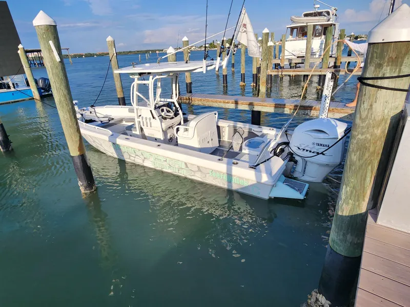 Slide: The Image of 2006 Everglades 243 CC boat docked at a marina with Yamaha outboard motor. - 8