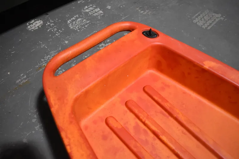 Slide: The Image of Orange Ascend 12R Sport Sit-On kayak, 2021 model, showing handle and drain plug. - 12