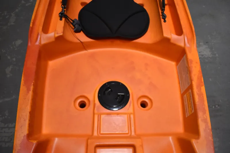 Slide: The Image of Orange Ascend 12R Sport Sit-On kayak, 2021 model, featuring a comfortable seat and storage hatch. - 9