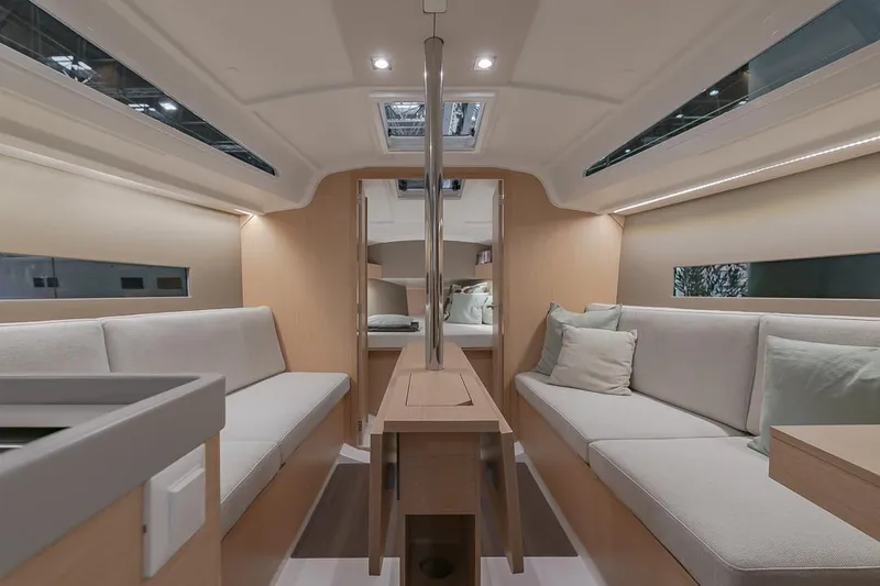 Slide: The Image of Interior of 2024 Beneteau Oceanis 30.1 sailboat with modern seating and wooden finishes. - 1