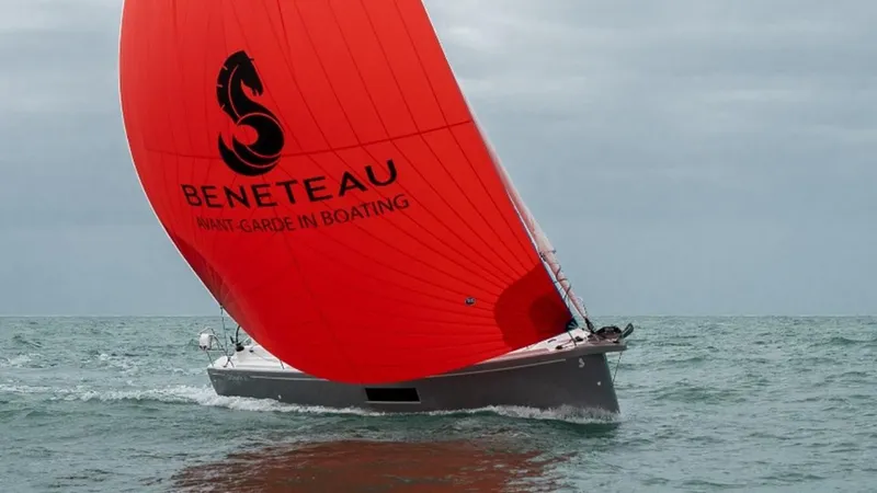 Slide: The Image of 2024 Beneteau Oceanis 30.1 sailing with a vibrant red sail on open water. - 19