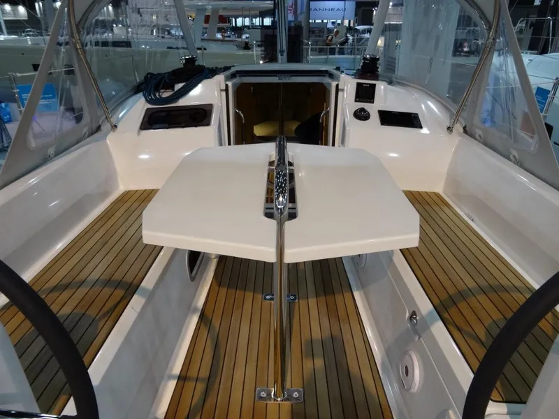 Slide: The Image of 2024 Beneteau Oceanis 30.1 cockpit with teak flooring and foldable table. - 13