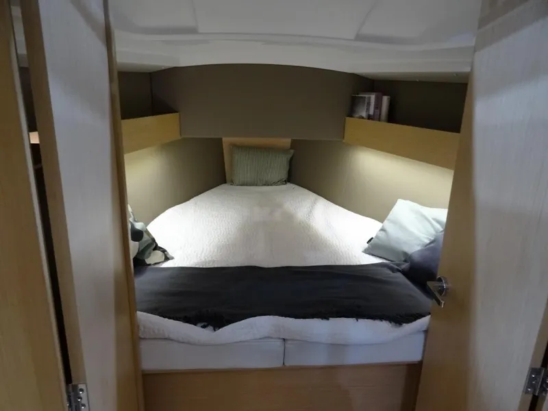 Slide: The Image of 2024 Beneteau Oceanis 30.1 cozy cabin with double bed and modern decor. - 17