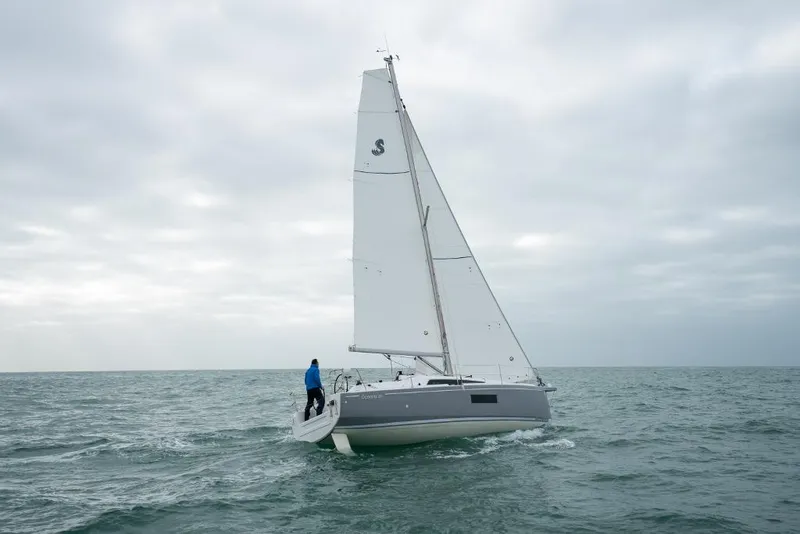 Slide: The Image of 2024 Beneteau Oceanis 30.1 sailboat on open water under cloudy sky. - 25
