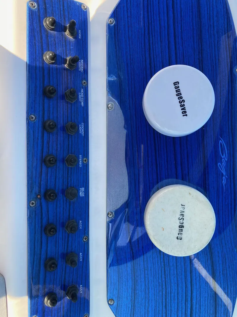 Slide: The Image of Blue control panel of a 2016 Baja 23 Islander boat with switches and gauges. - 10