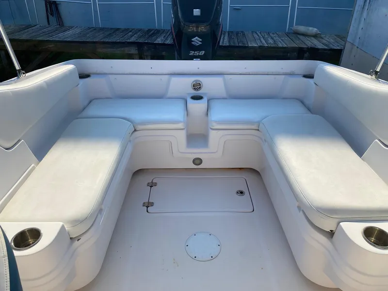 Slide: The Image of 2016 Baja 23 Islander boat with white cushioned seating and Suzuki 250 outboard motor. - 18