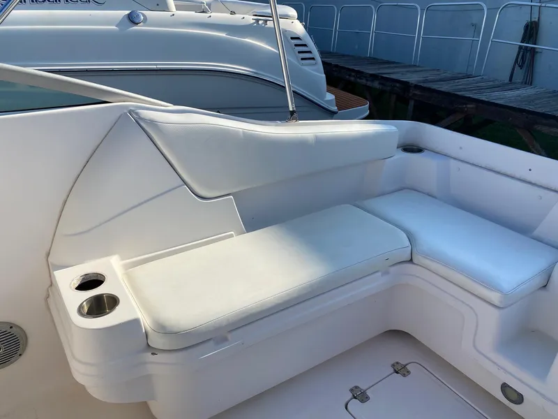 Slide: The Image of 2016 Baja 23 Islander boat with white cushioned seating and cup holders. - 22