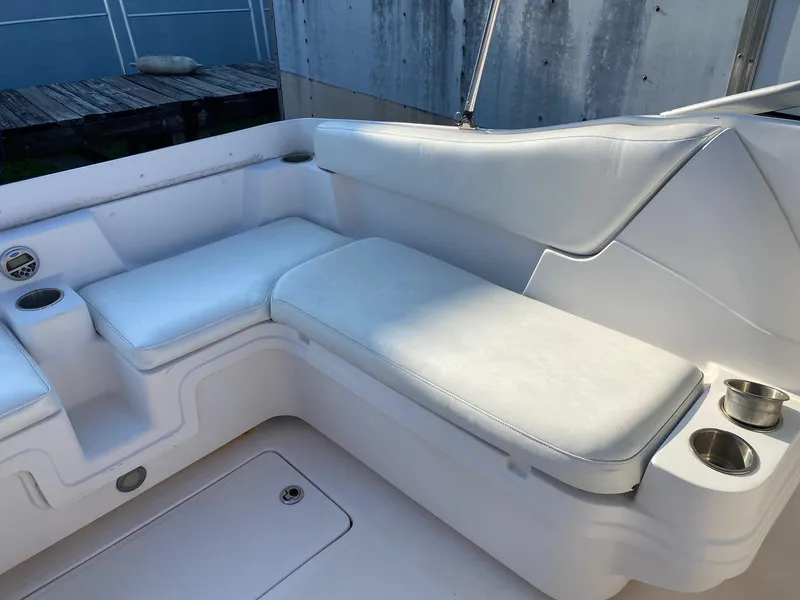 Slide: The Image of 2016 Baja 23 Islander boat interior with white cushioned seating. - 23