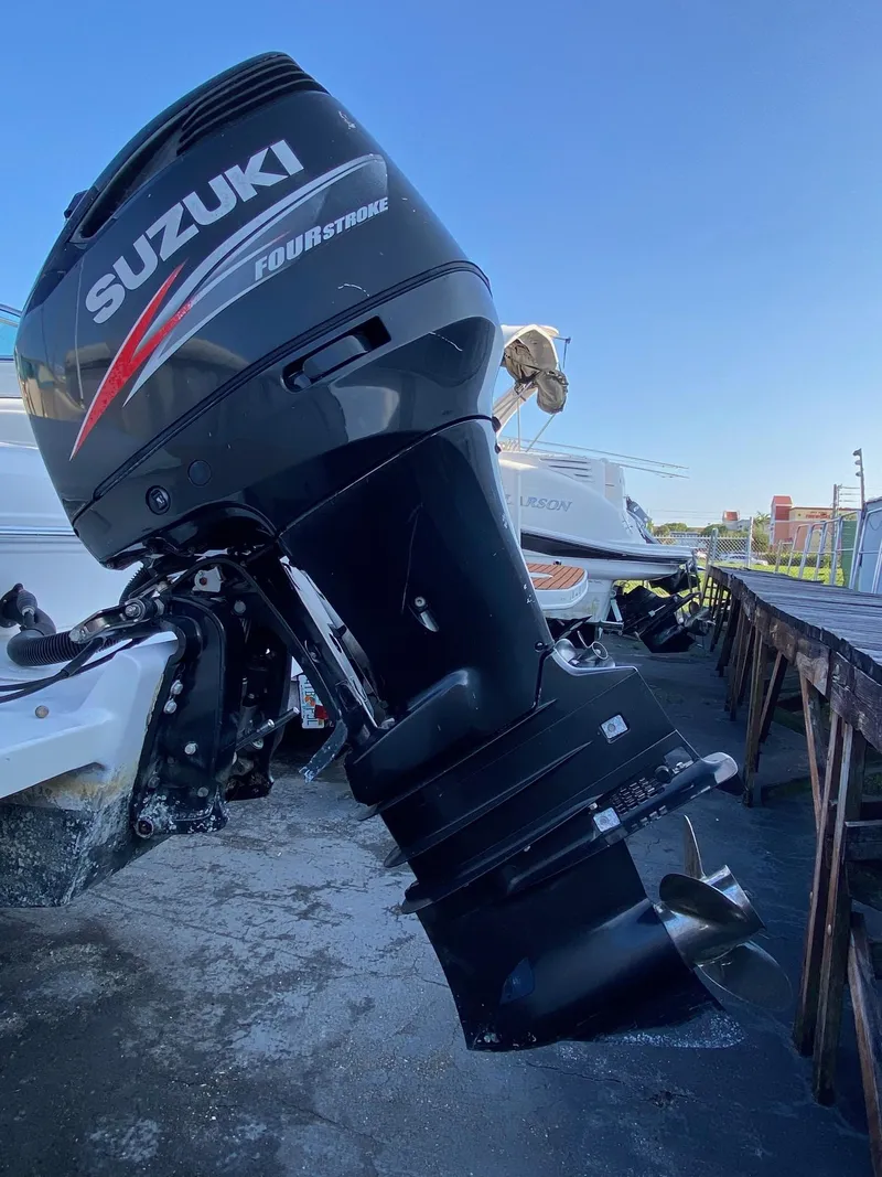 Slide: The Image of Suzuki four-stroke outboard motor on a 2016 Baja 23 Islander boat. - 26