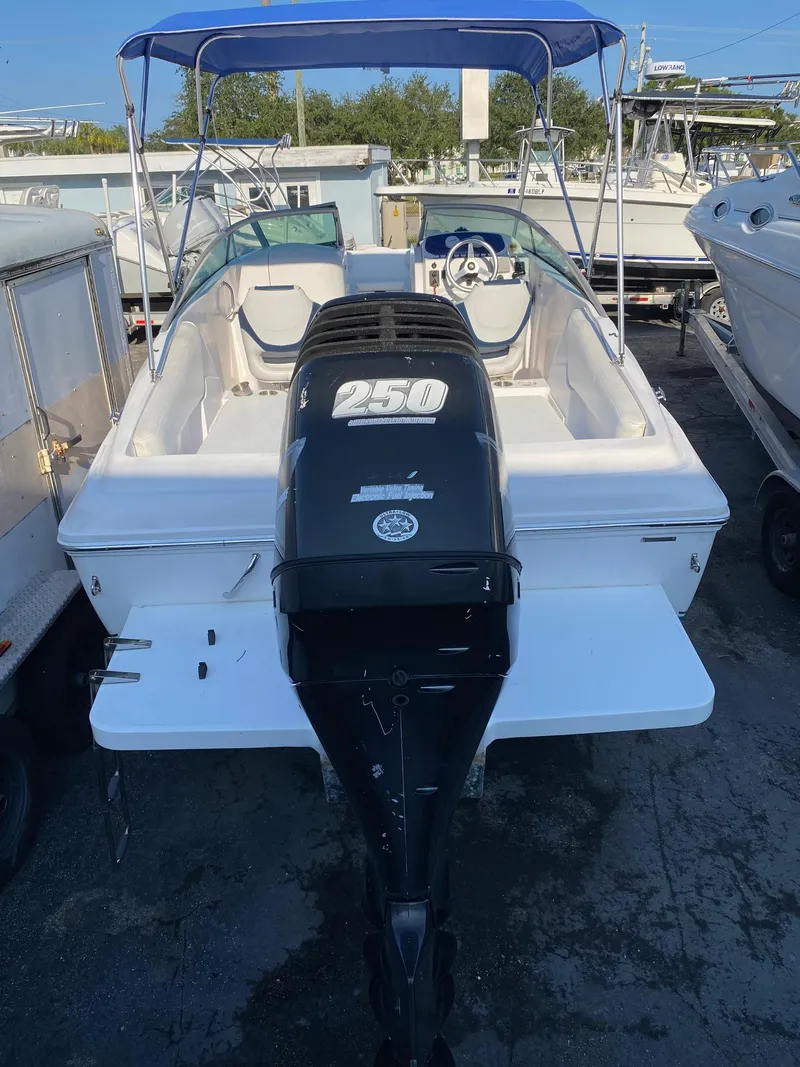 Slide: The Image of 2016 Baja 23 Islander boat with 250 HP outboard motor, blue canopy, and white interior. - 4