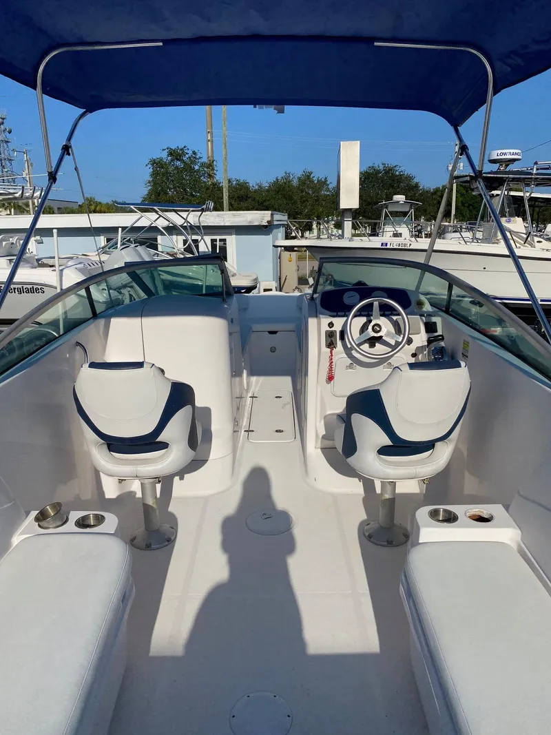 Slide: The Image of 2016 Baja 23 Islander boat interior with blue canopy and dual seating. - 5