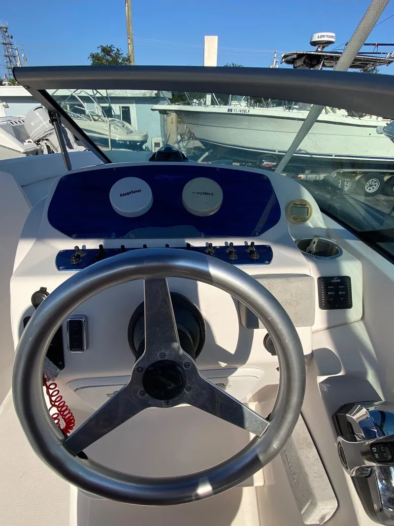 Slide: The Image of 2016 Baja 23 Islander boat dashboard with steering wheel and controls. - 9