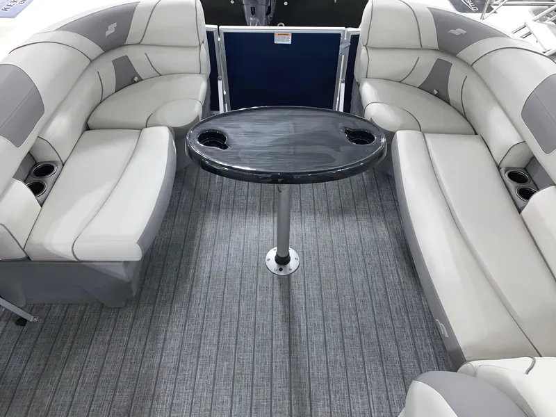Slide: The Image of 2024 Starcraft EX22 FD boat interior with gray seating and table. - 10