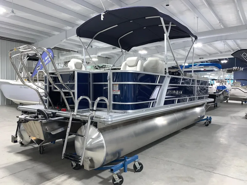 Slide: The Image of 2024 Starcraft EX22 FD pontoon boat with canopy in showroom. - 2