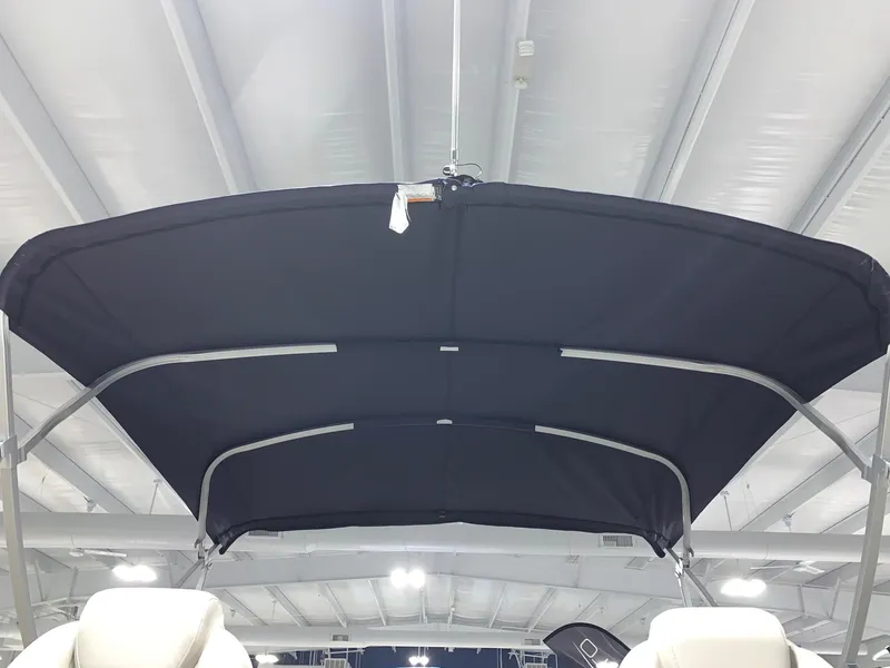 Slide: The Image of 2024 Starcraft EX22 FD boat with black bimini top in showroom. - 21