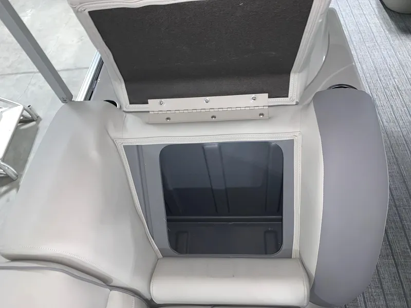 Slide: The Image of 2024 Starcraft EX22 FD boat storage compartment with open lid. - 7