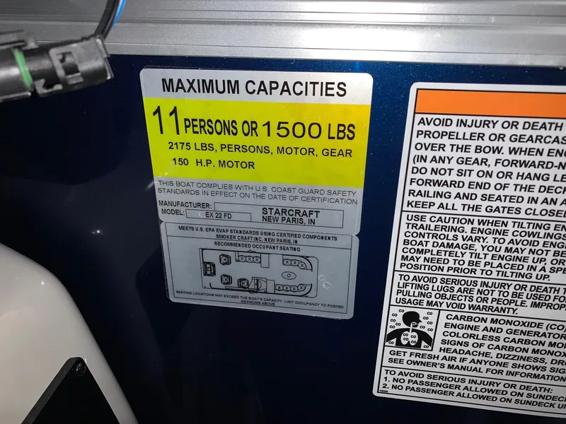 Slide: The Image of 2024 Starcraft EX22 FD boat capacity label, 11 persons or 1500 lbs, 150 HP motor. - 15