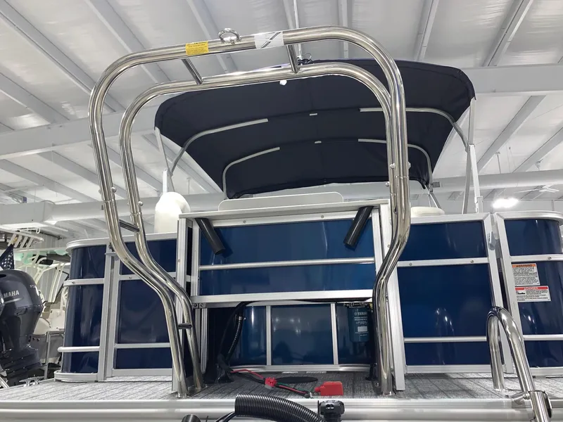 Slide: The Image of 2024 Starcraft EX22 FD pontoon boat with rear entry ladder and canopy. - 2